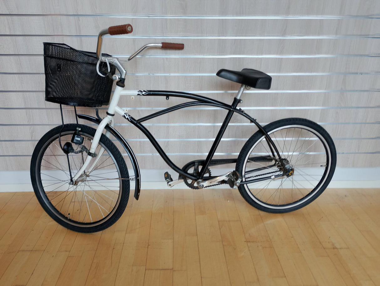 Svart och vit vintagecykel med korg och bruna handtag, herrcykel