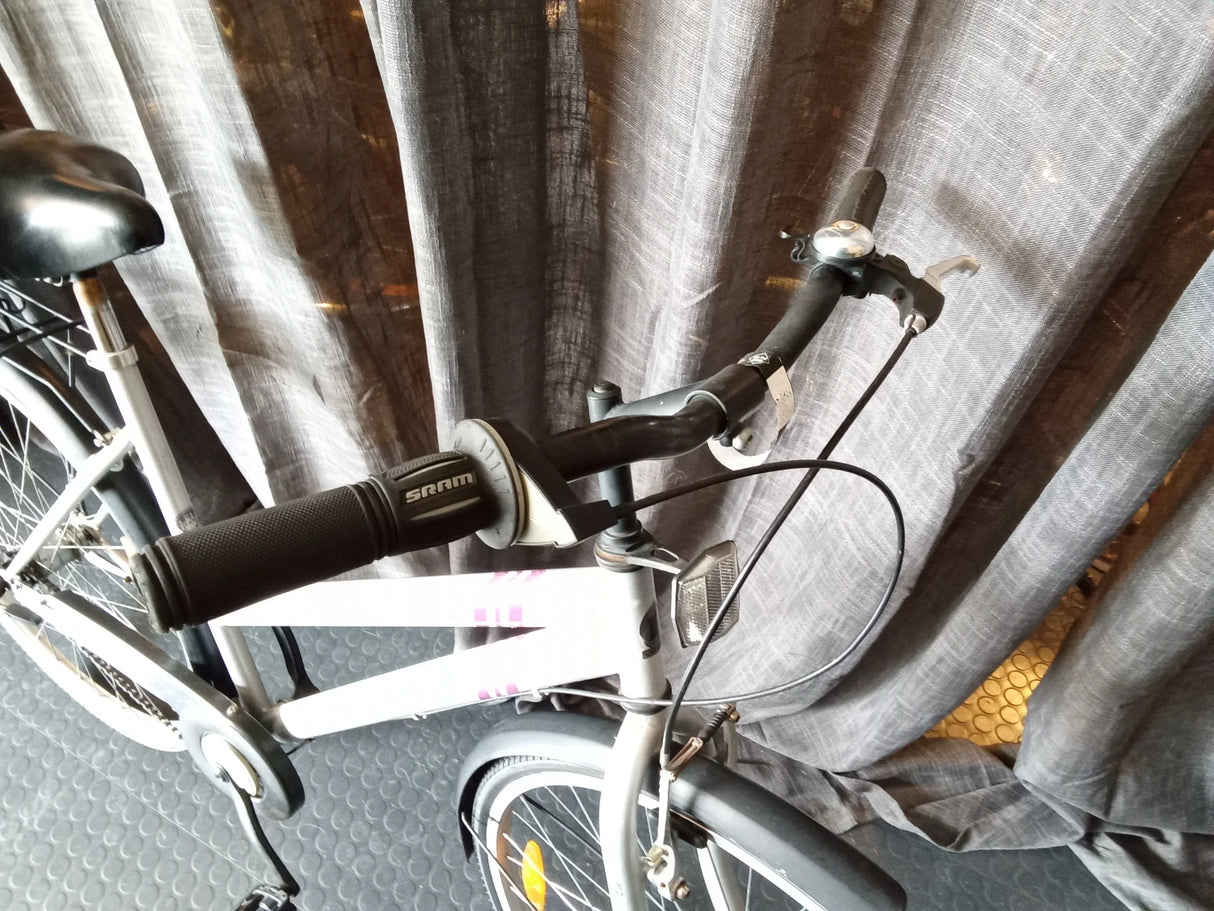 Vitt cykelstyre med svart SRAM-grepp och bromshandtag på stadscykel