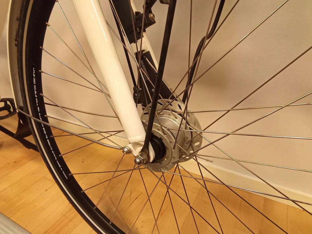 framhjul på cykel med vit ram och Shimano navmotor