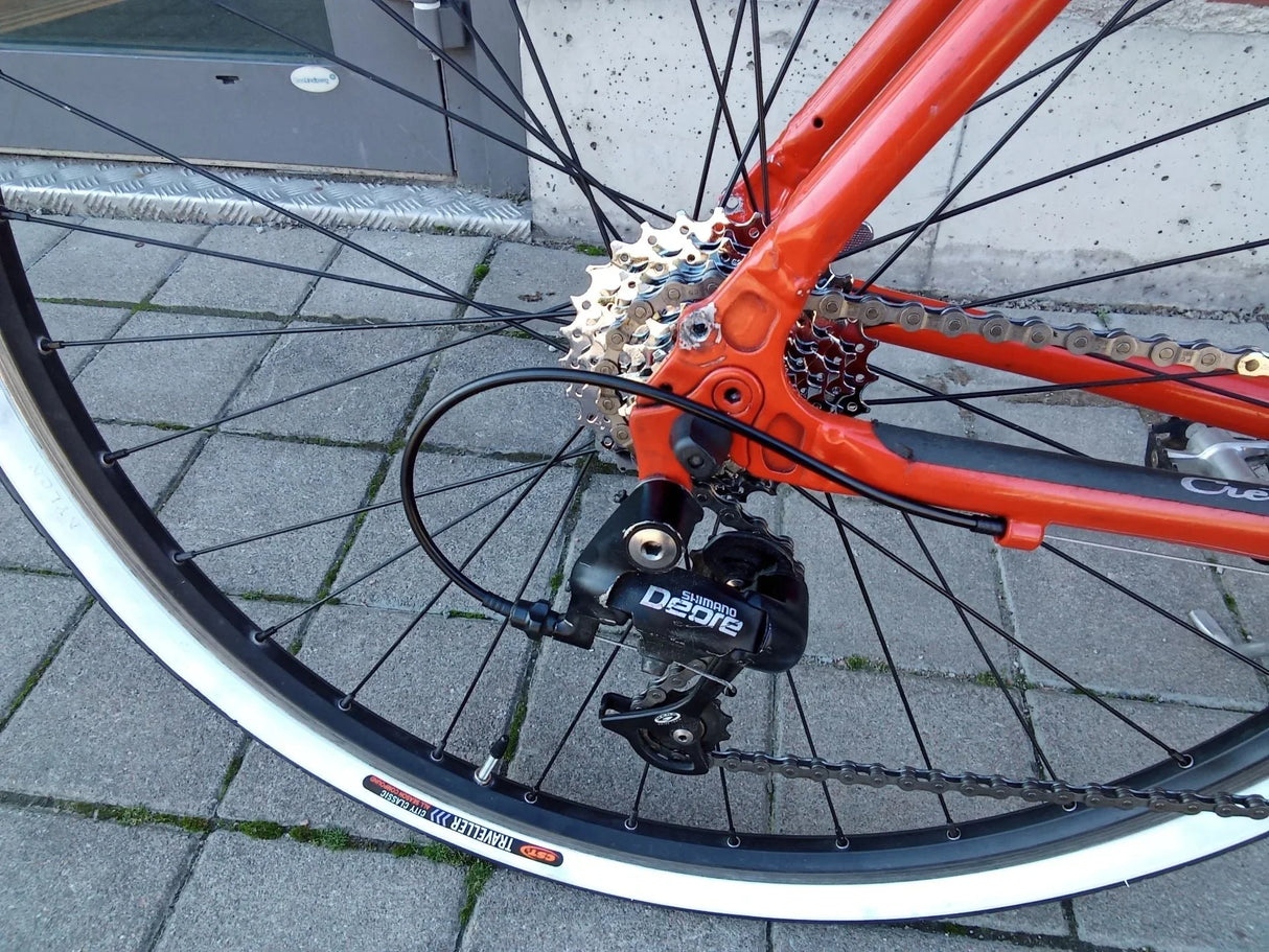Röd cykel med Shimano Deore växelmekanism och CST Traveller däck