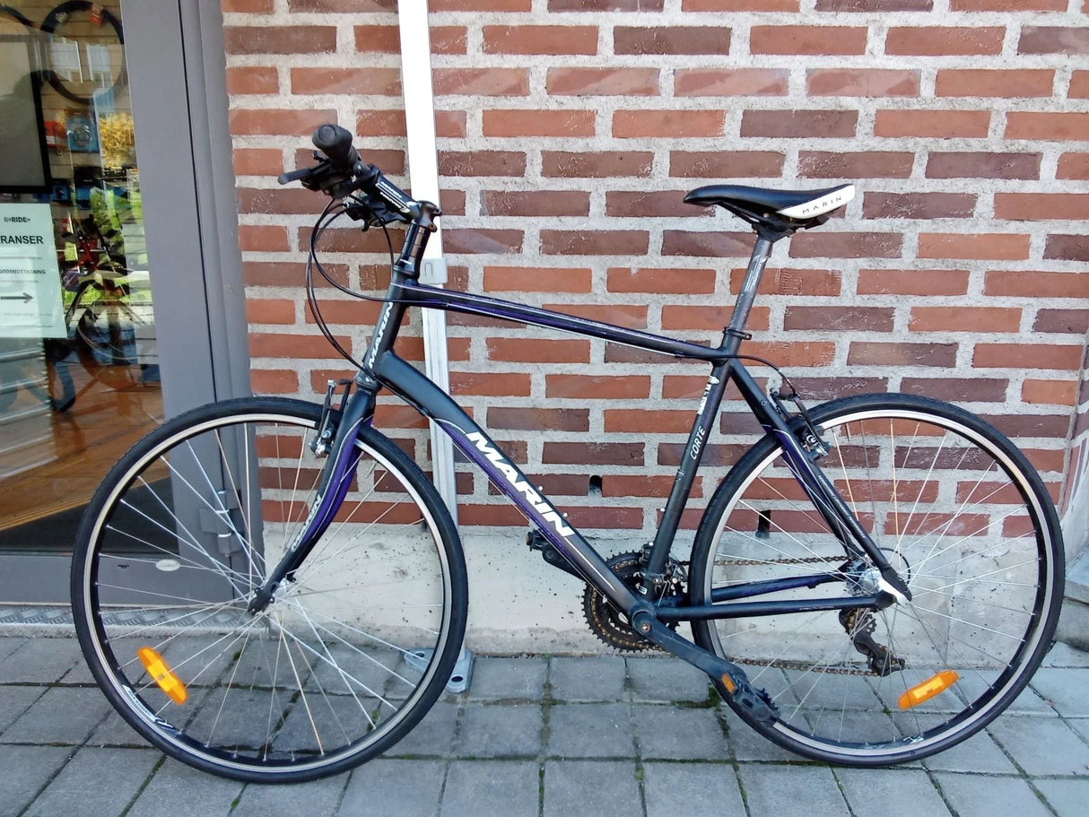 Svart Marin Corte terrängcykel med smala däck och reflexer på hjulen