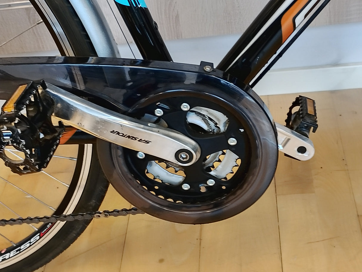 cykelpedal och Shimano-vevarm med kedjeskydd på sportcykel